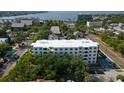 Aerial view of condo building surrounded by lush trees, with a glimpse of the water in the distance at 406 W Cedar St # 403, Tampa, FL 33606