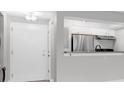 View of entryway with stainless steel appliances in the kitchen area beyond at 406 W Cedar St # 403, Tampa, FL 33606