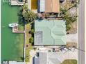 Top-down aerial view of home showcasing the roof, landscaping, and waterfront location with dock at 540 115Th Ave, Treasure Island, FL 33706