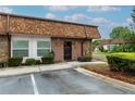 Inviting front entrance with decorative stone accents, a decorative front door, and lush landscaping at 6188 Chesham Dr # 5, New Port Richey, FL 34653