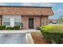 Close-up of the front door with decorative accents and well-maintained landscaping at 6188 Chesham Dr # 5, New Port Richey, FL 34653