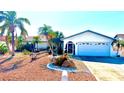 White house with a desert-style rock garden in the front, and palm trees in a bright neighborhood at 6526 Senegal Palm Way, Apollo Beach, FL 33572