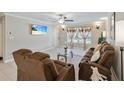 Inviting living room with tile flooring, comfy reclining sofa, and large windows at 904 Woodland Dr, Seffner, FL 33584