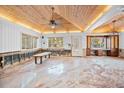 Sunroom features a wood ceiling, ample natural light, and an open layout ready for renovation at 106 23Rd Ave, St Pete Beach, FL 33706