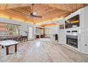 Sunroom showcasing wood ceiling, fireplace, built-ins, and open layout ready for renovation at 106 23Rd Ave, St Pete Beach, FL 33706