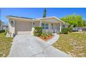 Charming single-story home featuring a well-maintained yard and attached garage at 1103 Conoley Ln, Holiday, FL 34691