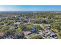 A scenic aerial view of a neighborhood near the water, highlighting lush greenery and community layout at 1201 Kapok Kove Cir, Clearwater, FL 33759
