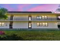 Condo exterior view showing balconies, lush lawn, and easy access to units at 12300 Vonn Rd # 2204, Largo, FL 33774