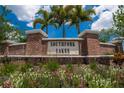 Welcome to Southfork Lakes, a beautiful community! Brick sign with pretty landscaping and a bright blue sky at 14050 Arbor Pines Dr, Riverview, FL 33579