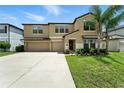 Charming two-story home featuring a two-car garage, landscaped yard, and welcoming front entrance at 14050 Arbor Pines Dr, Riverview, FL 33579