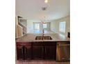 Kitchen view showcases island sink, stainless appliances, and open layout to living area at 14050 Arbor Pines Dr, Riverview, FL 33579