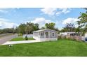 Well-maintained single-story home featuring a spacious front yard and covered porch at 1423 Venetia St, Nokomis, FL 34275