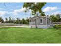 Well-maintained single-story home featuring a spacious front yard and covered porch at 1423 Venetia St, Nokomis, FL 34275