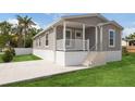 Charming single-story home with a covered front porch and well-maintained lawn and newly installed driveway at 1423 Venetia St, Nokomis, FL 34275