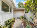 A walkway between a house and a garden at 1531 Picardy Cir, Clearwater, FL 33755
