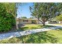 View of the exterior of the home and green lawn from sidewalk at 1764 St Croix Dr, Clearwater, FL 33759
