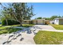 Exterior view of house with long driveway and green lawn at 1764 St Croix Dr, Clearwater, FL 33759