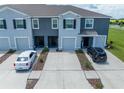 Townhome complex showcases modern facades, driveways, and well-maintained landscaping, creating an inviting community atmosphere at 1967 Hovenweep Rd, Wesley Chapel, FL 33543