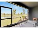 Screened patio overlooks a green landscape with a pond, providing a serene outdoor living space at 1967 Hovenweep Rd, Wesley Chapel, FL 33543
