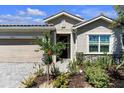 Well-manicured front yard with a stone accent and neatly trimmed bushes at 20647 Ovid Ln, Venice, FL 34293