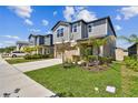 Charming two-story home featuring a two-car garage, neutral color palette and well-manicured landscaping at 22287 Storybook Cabin Way, Land O Lakes, FL 34637