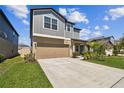 Charming two-story home featuring a two-car garage, neutral color palette and well-manicured landscaping at 22287 Storybook Cabin Way, Land O Lakes, FL 34637