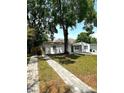 Well-maintained single-story home with paver driveway and lovely yard at 2315 Carroll Pl, Tampa, FL 33612