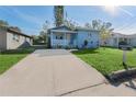 View of light blue home with a concrete driveway at 2418 N Links Ave, Sarasota, FL 34234