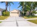 Charming single-story home boasting mature landscaping and a large driveway at 29013 Old Marsh End, Wesley Chapel, FL 33543