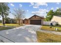Attractive single-Gathering home featuring a spacious driveway, mature trees, and well-kept landscaping at 2974 Sean Way, Palm Harbor, FL 34684