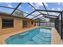 Sparkling in-ground pool enclosed by a screened lanai, offering a private outdoor retreat at 2974 Sean Way, Palm Harbor, FL 34684