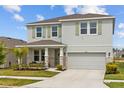 Charming two-story home with a well-manicured lawn and a two-car garage at 33645 Elm Hill Br, Wesley Chapel, FL 33545
