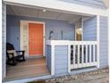 Charming covered front porch, adorned with dolphin art, and rocking chair at 3710 W Tacon St, Tampa, FL 33629