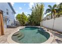 Private backyard pool featuring a lush tropical landscaped patio and waterfall at 3710 W Tacon St, Tampa, FL 33629