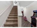 Staircase leading to the upper level with a view of the hallway, and fun game machines at 5946 81St N Ave, Pinellas Park, FL 33781