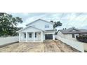 Charming two-story home with a covered front porch and an attached garage at 745 31St N Ave, St Petersburg, FL 33704