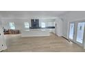 Bright, open-concept kitchen featuring white cabinets, a large island, and stainless steel appliances at 745 31St N Ave, St Petersburg, FL 33704