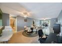 Open floorplan living space featuring a dining area, computer desk, and a seating area at 7700 92Nd St # 207, Seminole, FL 33777