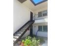 Charming condo with a staircase leading to upper-level units and vibrant landscaping at 7701 Starkey Rd # 602, Seminole, FL 33777