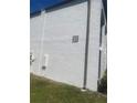 Exterior angle view showing building 21, set against a sunny, grassy landscape at 7701 Starkey Rd # 602, Seminole, FL 33777