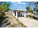 The exterior of this property has a light green paint, a covered car port and partial fencing at 9208 N 27Th St, Tampa, FL 33612