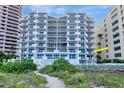 Beachfront condo with multiple balconies offering panoramic ocean views and lush landscaping at 1350 Gulf Blvd # 301, Clearwater Beach, FL 33767