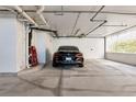 Well-lit garage parking spot with black car at 1350 Gulf Blvd # 301, Clearwater Beach, FL 33767
