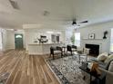 Bright living room featuring a fireplace, modern furniture, and an open view of the kitchen at 10408 N 50Th St # 1/2, Tampa, FL 33617