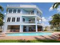 Beautiful three-story home with a pool, patio, and outdoor kitchen for entertaining at 11105 5Th E St, Treasure Island, FL 33706