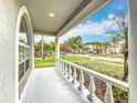 Covered front porch with decorative white railing offering a view of the neighborhood at 11414 Weston Course Loop, Riverview, FL 33579