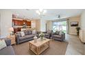 Open-concept living area with tile floors, neutral colors, and abundant natural light at 1155 Lawnview Ter, New Port Richey, FL 34655