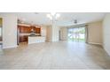 Expansive living space featuring tiled flooring, opening up to the kitchen and outdoor views at 1155 Lawnview Ter, New Port Richey, FL 34655