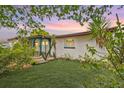 Charming home with a well maintained lawn and exterior featuring Florida vegetation at 11705 Ibis Ln, Port Richey, FL 34668