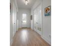 Bright hallway with hardwood floors, white trim, and stylish decor, leading to various rooms at 1550 48Th N Ave, St Petersburg, FL 33703
